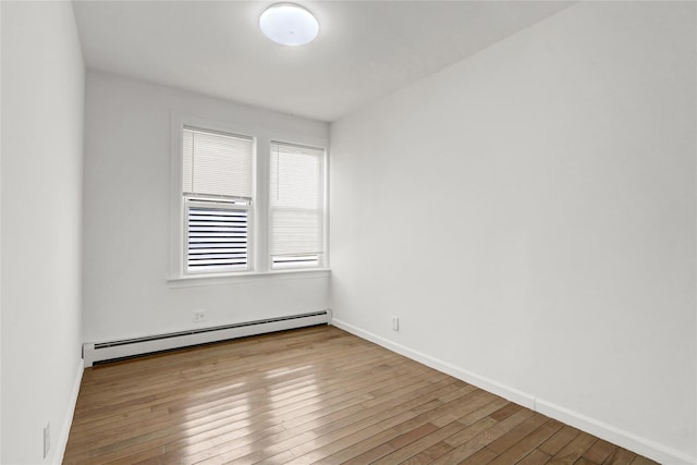 48-35 Clearview Expy, Bayside, NY 11364 - spare room with baseboard heating and wood-type flooring
