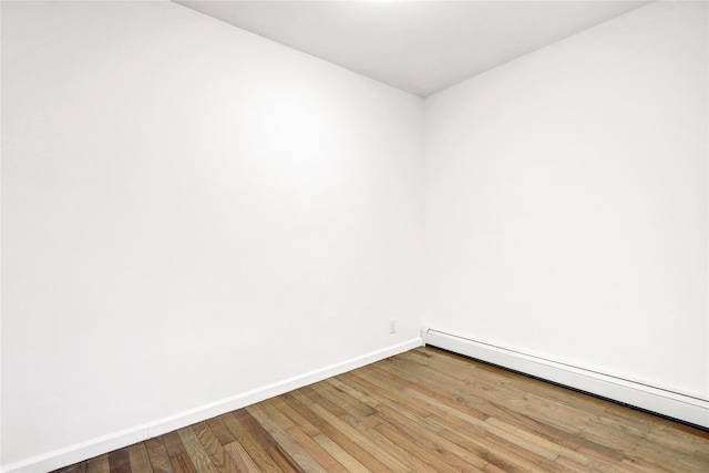 48-35 Clearview Expy, Bayside, NY 11364 - unfurnished room featuring a baseboard radiator and wood finished floors