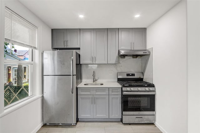 48-35 Clearview Expy, Bayside, NY 11364 - kitchen featuring stainless steel appliances, gray cabinetry, under cabinet range hood, decorative backsplash, and light countertops