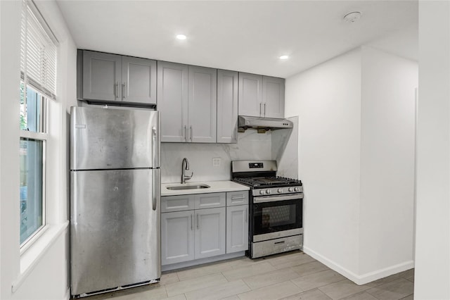 48-35 Clearview Expy, Bayside, NY 11364 - kitchen with stainless steel appliances, under cabinet range hood, gray cabinets, decorative backsplash, and light countertops
