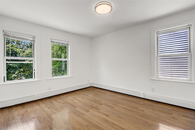 48-35 Clearview Expy, Bayside, NY 11364 - unfurnished room with wood finished floors and a baseboard radiator