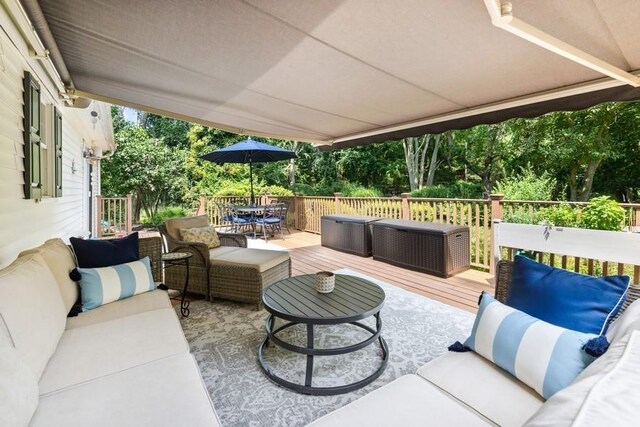 735 Deerfoot Path, Cutchogue, NY 11935 - view of patio / terrace featuring an outdoor hangout area, a wooden deck, outdoor dining space, and view of scattered trees