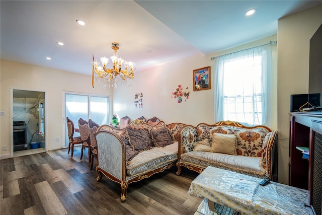 living room featuring a notable chandelier, recessed lighting, and wood finished floors