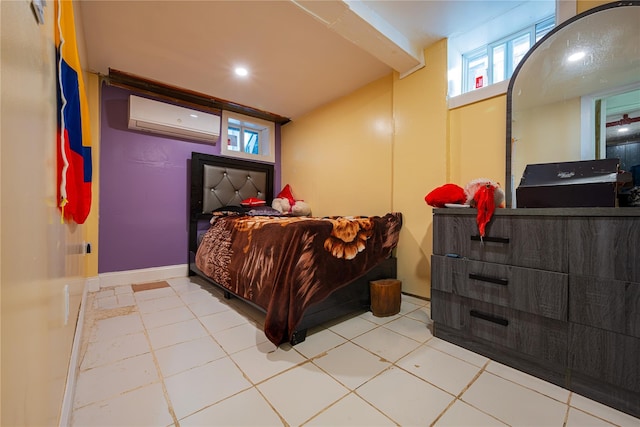 bedroom with tile patterned floors, a wall mounted AC, and baseboards