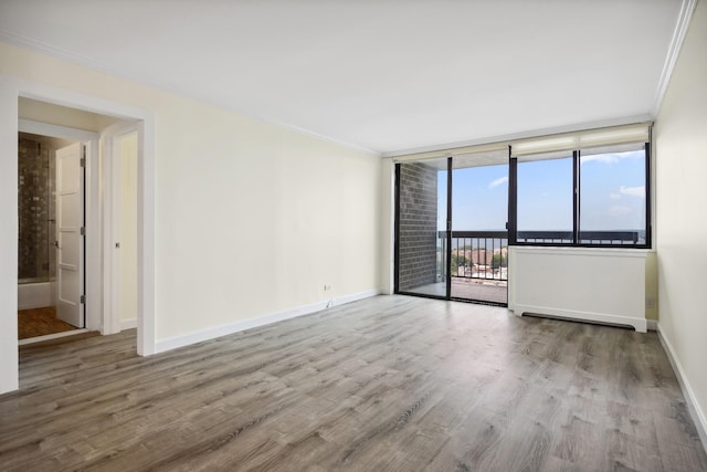 2 Bay Club Dr Unit 17Z2, Bayside, NY 11360 - empty room featuring wood finished floors, crown molding, and expansive windows