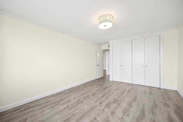 2 Bay Club Dr Unit 17Z2, Bayside, NY 11360 - unfurnished bedroom featuring ornamental molding, light wood finished floors, and a closet