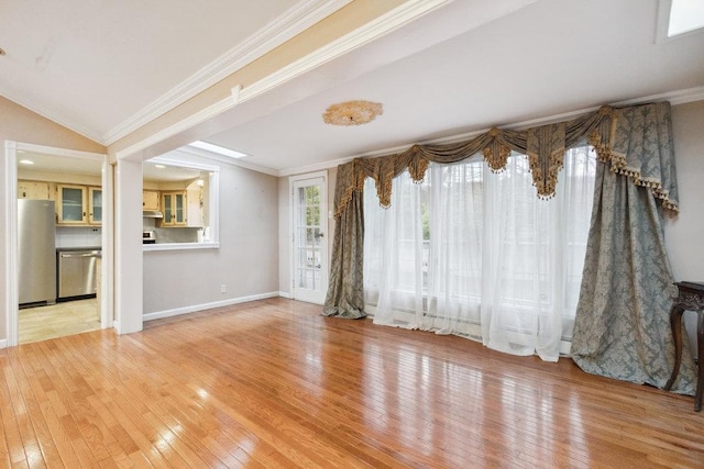 unfurnished living room with crown molding, light wood-style flooring, and baseboards