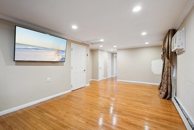 spare room featuring light wood-type flooring, a baseboard heating unit, baseboards, and recessed lighting