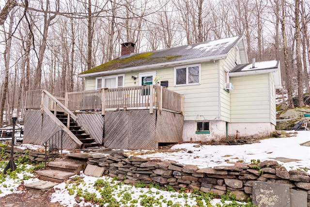 view of front of home featuring stairway, a deck, and a chimney