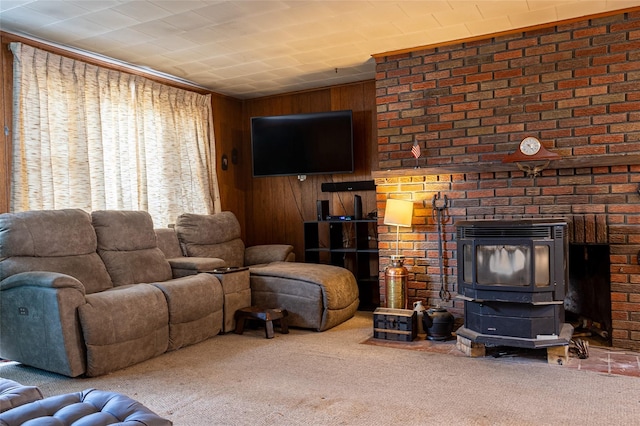 carpeted living area featuring wood walls and a wood stove