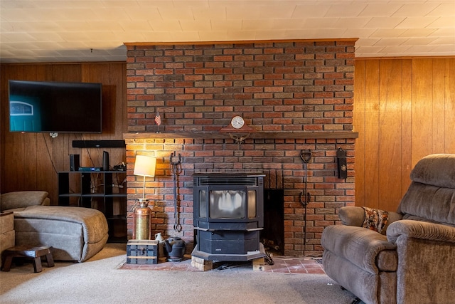 carpeted living room with wood walls and a wood stove