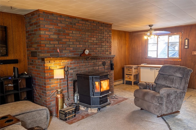 living room featuring wood walls and a wood stove