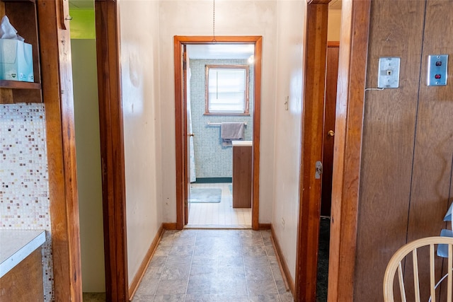 hall featuring baseboards