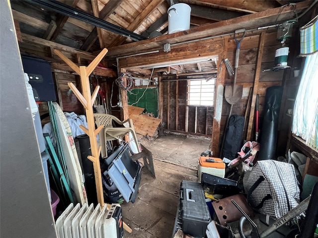 miscellaneous room featuring vaulted ceiling and radiator