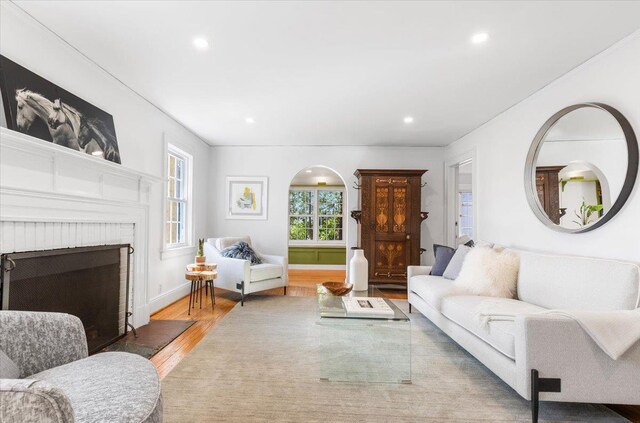 living area with plenty of natural light, wood finished floors, and recessed lighting