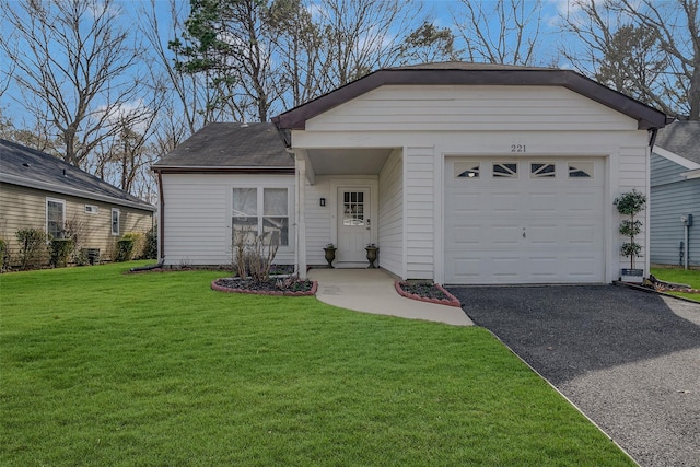 ranch-style home with driveway, a front yard, and an attached garage