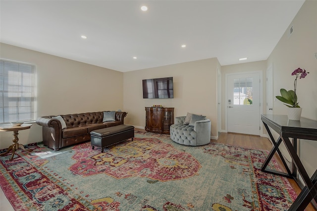 living room with visible vents, recessed lighting, baseboards, and wood finished floors