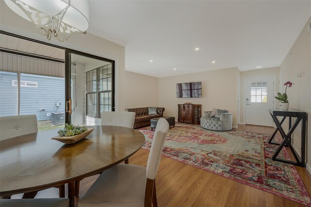 dining room featuring recessed lighting, an inviting chandelier, and wood finished floors