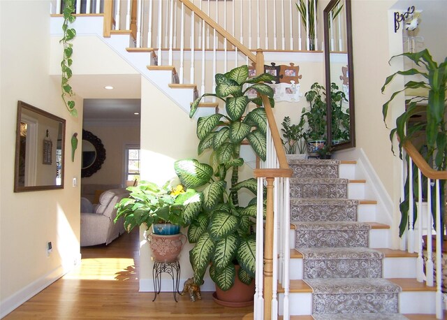 stairs with recessed lighting, baseboards, and wood finished floors