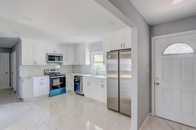 17 Windmill Ln, Levittown, NY 11756 - kitchen with light countertops, a sink, tasteful backsplash, stainless steel appliances, and marble finish floor