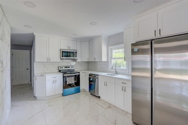17 Windmill Ln, Levittown, NY 11756 - kitchen featuring marble finish floor, a sink, tasteful backsplash, and appliances with stainless steel finishes