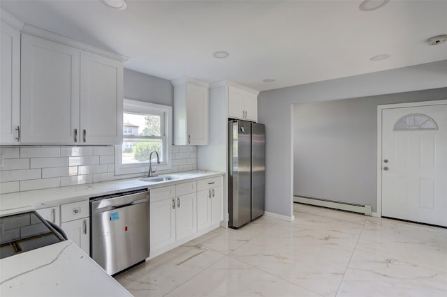 17 Windmill Ln, Levittown, NY 11756 - kitchen with stainless steel appliances, baseboard heating, tasteful backsplash, a sink, and light stone counters