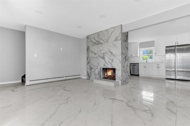 17 Windmill Ln, Levittown, NY 11756 - unfurnished living room featuring a sink, a premium fireplace, marble finish floor, baseboards, and a baseboard heating unit