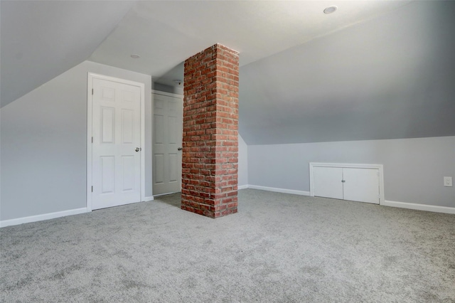 17 Windmill Ln, Levittown, NY 11756 - additional living space featuring decorative columns, carpet, baseboards, and lofted ceiling