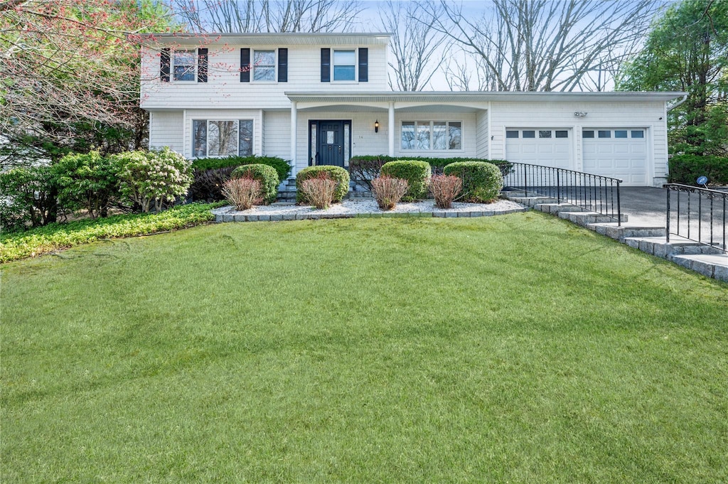14 Reeback Dr, Ossining, NY 10562 - view of front facade with a front lawn, driveway, and an attached garage