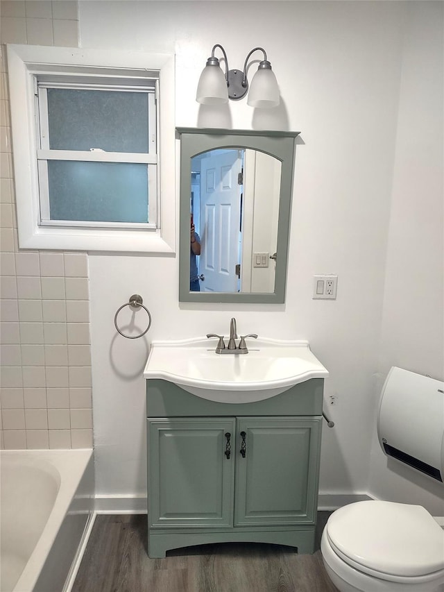 full bathroom with vanity, toilet, wood finished floors, and baseboards