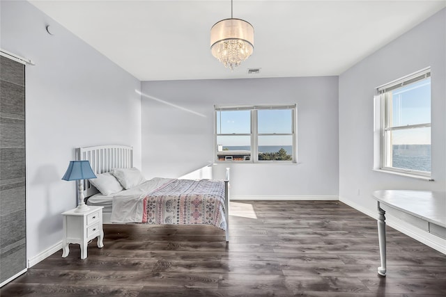 125 S Bay Dr, Babylon, NY 11702 - bedroom featuring wood finished floors, a chandelier, and baseboards