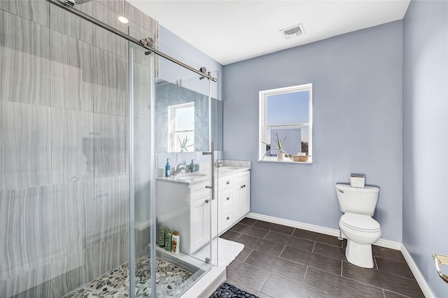 125 S Bay Dr, Babylon, NY 11702 - full bathroom with double vanity, a stall shower, toilet, and baseboards