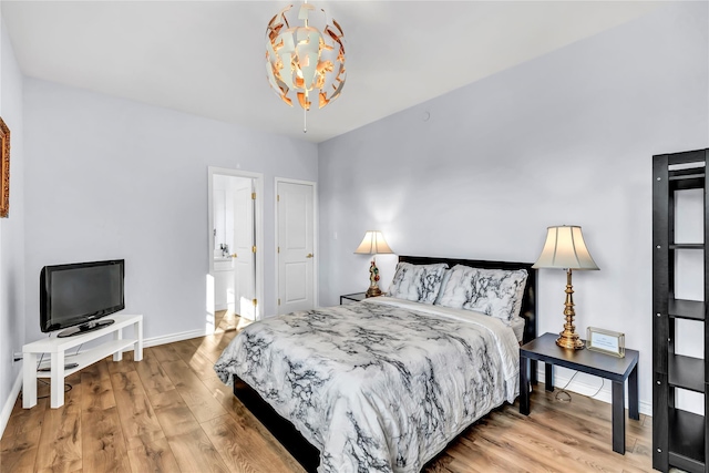 125 S Bay Dr, Babylon, NY 11702 - bedroom featuring baseboards, wood finished floors, and a chandelier