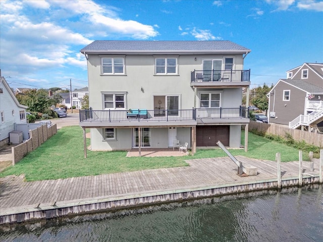125 S Bay Dr, Babylon, NY 11702 - rear view of property with stucco siding, a deck with water view, and a balcony
