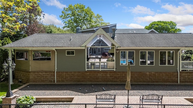 10 Crick Holly Ln, East Islip, NY 11730 - back of property with roof with shingles and a patio
