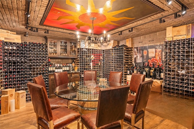10 Crick Holly Ln, East Islip, NY 11730 - wine area with track lighting, a chandelier, and wood finished floors