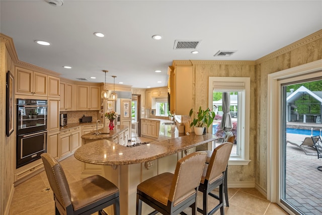 10 Crick Holly Ln, East Islip, NY 11730 - kitchen featuring light tile patterned flooring, an island with sink, a sink, a breakfast bar area, and backsplash