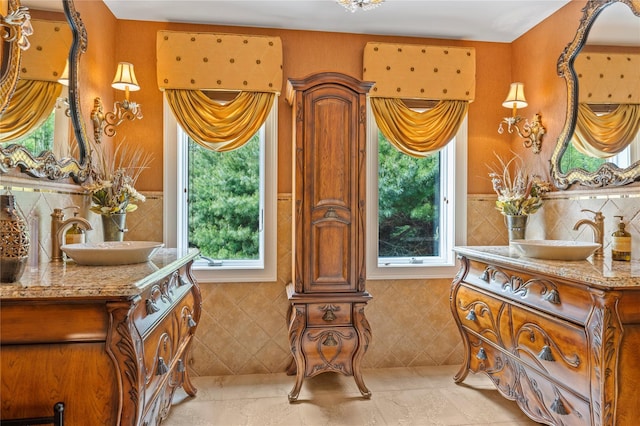 10 Crick Holly Ln, East Islip, NY 11730 - full bathroom featuring two vanities, healthy amount of natural light, and tile walls