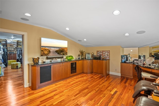 10 Crick Holly Ln, East Islip, NY 11730 - kitchen with brown cabinets, light wood-style floors, beverage cooler, lofted ceiling, and recessed lighting
