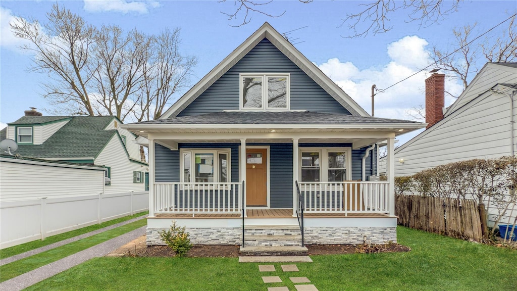 51 Hapsburg Pl, Hempstead, NY 11550 - bungalow-style house with a porch, roof with shingles, a front lawn, and fence