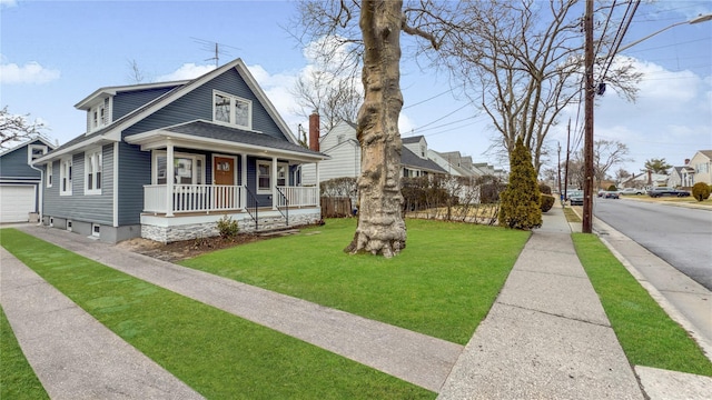 bungalow-style house with roof with shingles, a porch, a front lawn, an outdoor structure, and a garage
