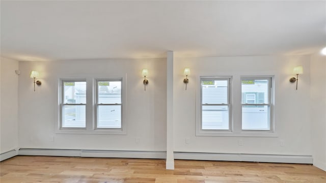 spare room featuring light wood-style flooring and a baseboard heating unit