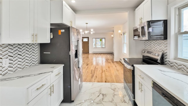 kitchen with a notable chandelier, marble finish floor, stainless steel appliances, white cabinets, and light stone countertops
