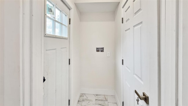 entryway featuring baseboards and marble finish floor