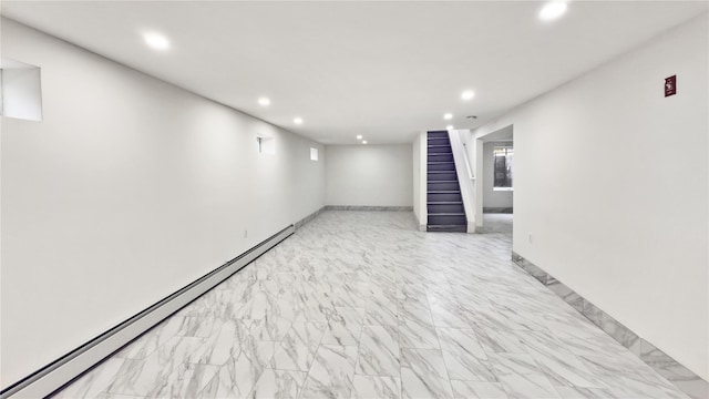 basement with baseboards, stairway, baseboard heating, recessed lighting, and marble finish floor