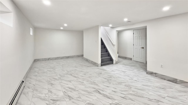 finished below grade area with baseboards, stairs, baseboard heating, recessed lighting, and marble finish floor