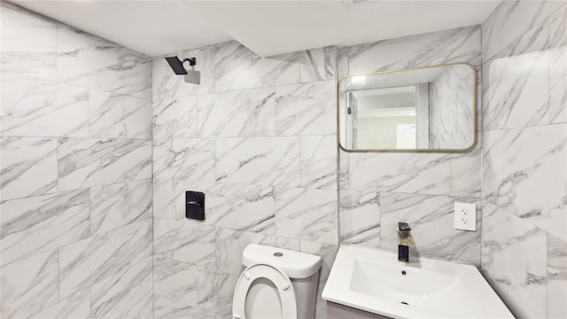 bathroom featuring vanity, tile walls, toilet, and a shower