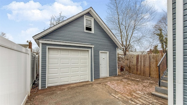 detached garage featuring fence
