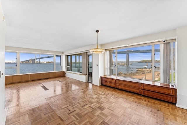 166-25 Powells Cove Blvd Unit 1A, Whitestone, NY 11357 - unfurnished sunroom featuring a chandelier and a water view
