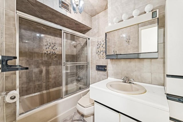 166-25 Powells Cove Blvd Unit 1A, Whitestone, NY 11357 - bathroom with tile walls, vanity, visible vents, backsplash, and enclosed tub / shower combo